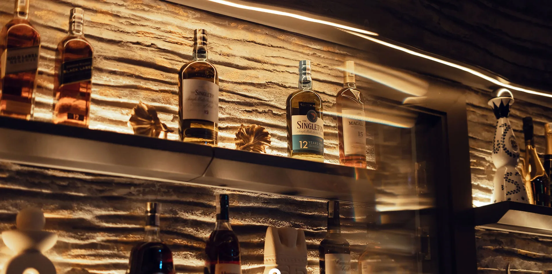 Premium whisky shelf featuring Johnnie Walker, Singleton 12, and Macallan 15 at Silk Lounge bar