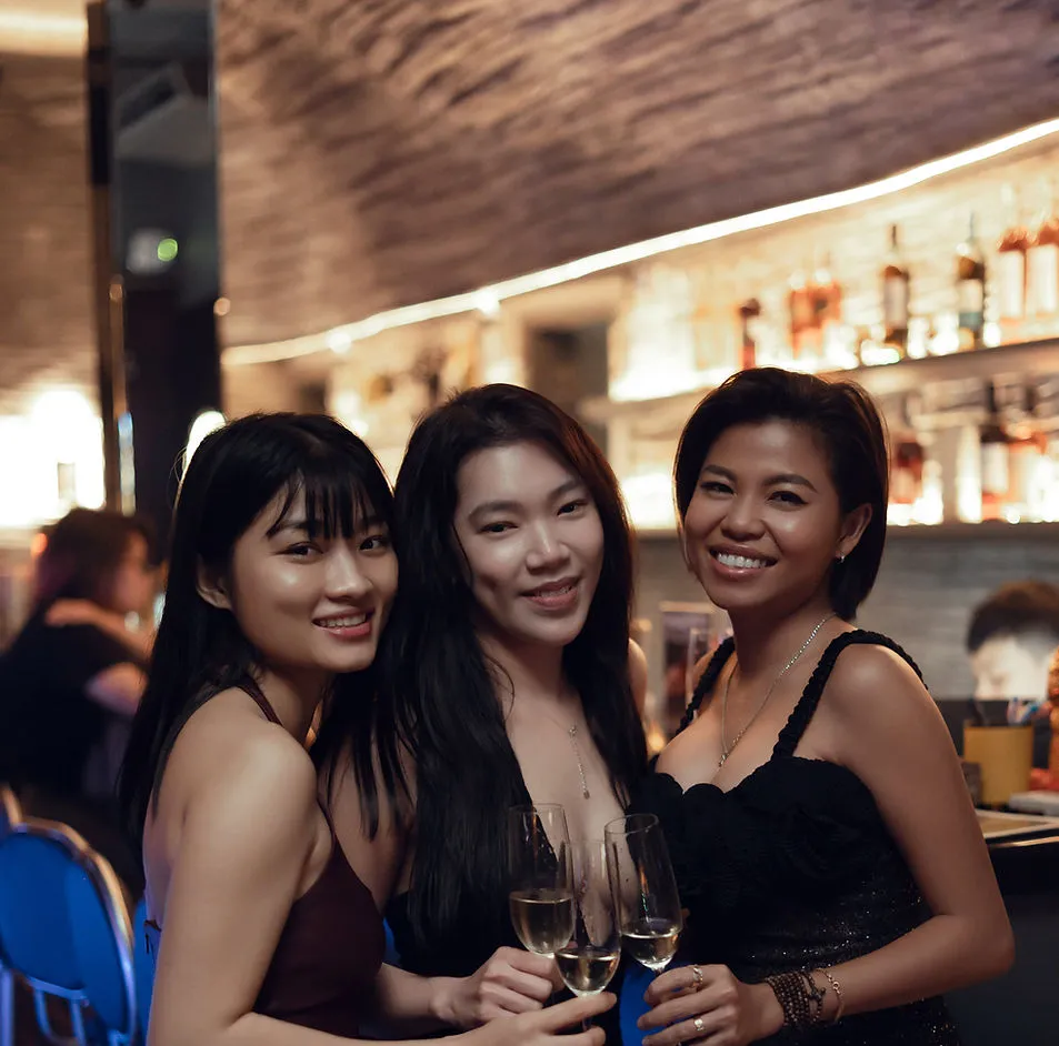 Three women enjoying champagne together at the Silk Lounge bar on Ladies Night